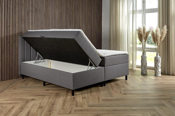 Antraciet boxspring comfort with built-in storage, showing the upholstered boxspring with storage drawers and a cozy mattress.