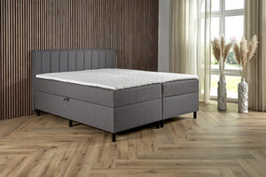 Antraciet Boxspring Comfort with built-in storage, featuring a padded headboard and sleek design from Bedden.nl.