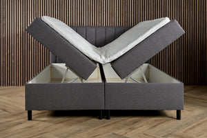 Antraciet boxspring bed with built-in storage from Bedden.nl, featuring a comfortable mattress and sleek design.