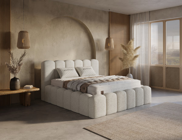 Beige boxspring bed with built-in storage drawers from Bedden.nl, featuring a sleek design and included mattress.